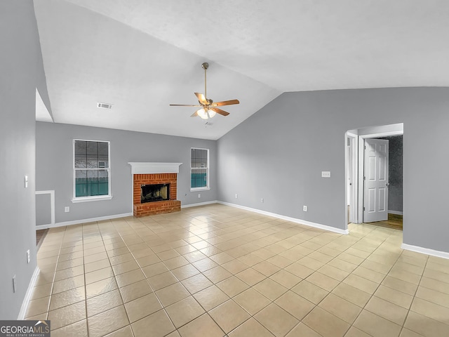 unfurnished living room featuring light tile patterned floors, a fireplace, visible vents, a ceiling fan, and vaulted ceiling