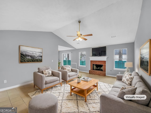 1681 Graystone Dr, Hampton, GA 30228 - living room with light tile patterned floors, vaulted ceiling, a ceiling fan, and a fireplace