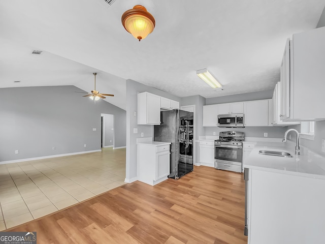 1681 Graystone Dr, Hampton, GA 30228 - kitchen with stainless steel appliances, open floor plan, light countertops, ceiling fan, and vaulted ceiling