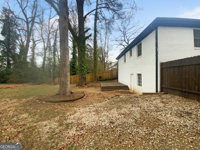 view of side of home featuring fence