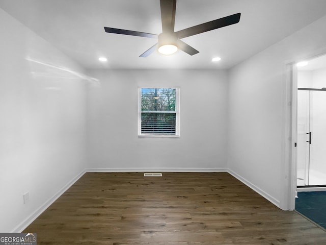 empty room with wood finished floors and baseboards