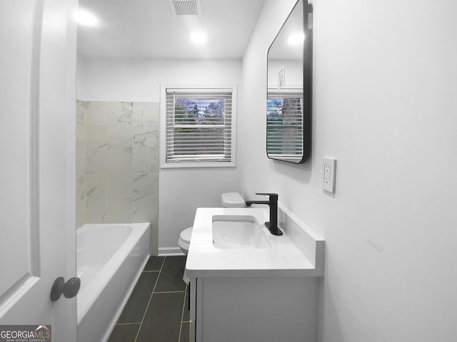 bathroom with toilet, vanity, visible vents, and tile patterned floors