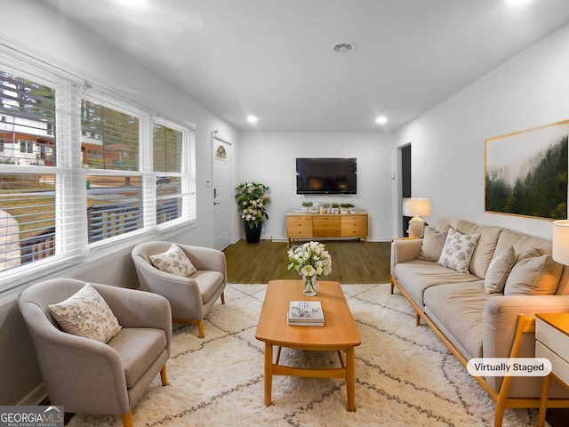 living area featuring visible vents, wood finished floors, and recessed lighting