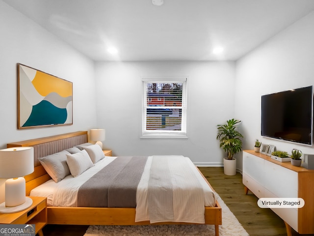 bedroom with recessed lighting, wood finished floors, and baseboards