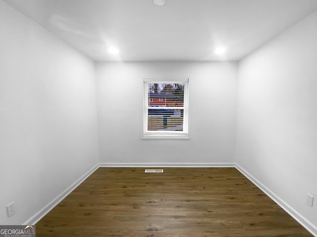 spare room featuring recessed lighting, visible vents, baseboards, and wood finished floors