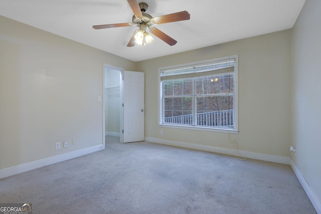 spare room featuring ceiling fan, baseboards, and carpet floors