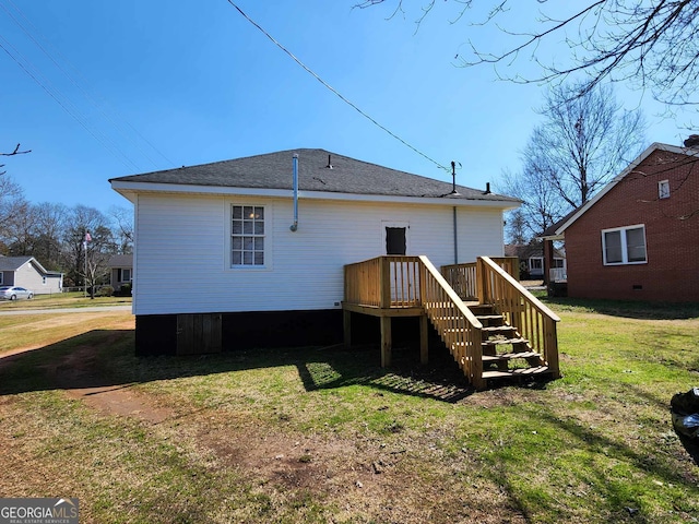 rear view of property featuring a lawn