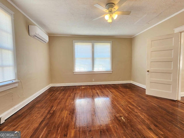 spare room with baseboards, a wall mounted air conditioner, wood-type flooring, and crown molding