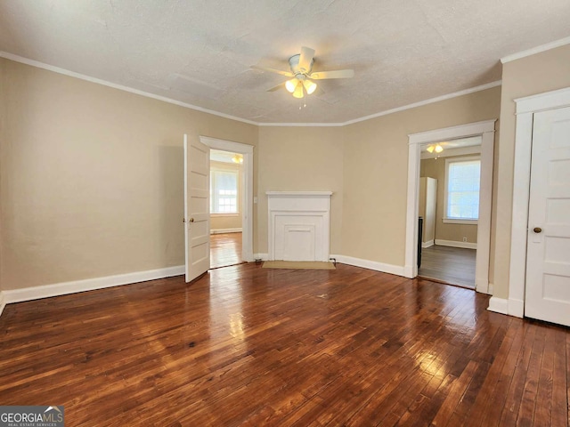 interior space featuring ornamental molding, baseboards, ceiling fan, and hardwood / wood-style floors