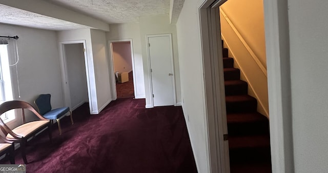 5546 Wellborn Creek Dr, Lithonia, GA 30058 - living area featuring dark colored carpet, a textured ceiling, stairway, and baseboards