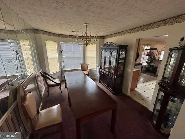 5546 Wellborn Creek Dr, Lithonia, GA 30058 - dining space with a chandelier, a textured ceiling, and light colored carpet