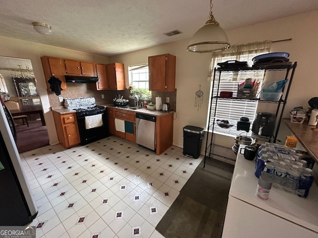 5546 Wellborn Creek Dr, Lithonia, GA 30058 - kitchen featuring black gas range, stainless steel dishwasher, under cabinet range hood, brown cabinets, and a textured ceiling