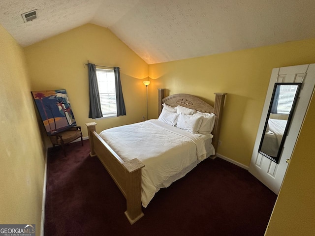5546 Wellborn Creek Dr, Lithonia, GA 30058 - carpeted bedroom featuring lofted ceiling, a textured ceiling, and baseboards