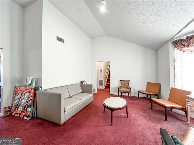 5546 Wellborn Creek Dr, Lithonia, GA 30058 - living area with carpet floors, stairway, a textured ceiling, and high vaulted ceiling