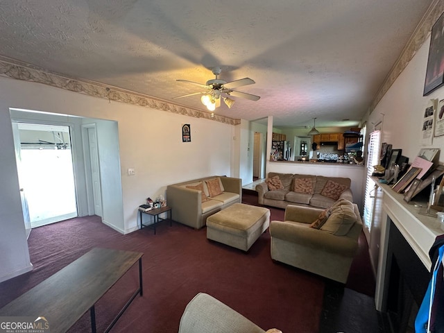 5546 Wellborn Creek Dr, Lithonia, GA 30058 - carpeted living room featuring a ceiling fan, a textured ceiling, and a fireplace