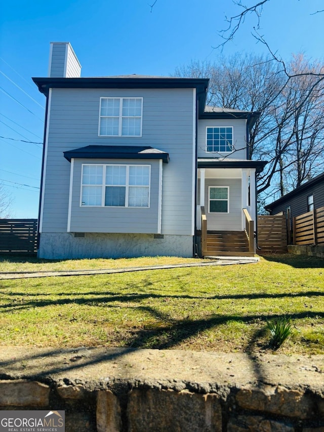 exterior space with crawl space, a chimney, fence, and a front yard