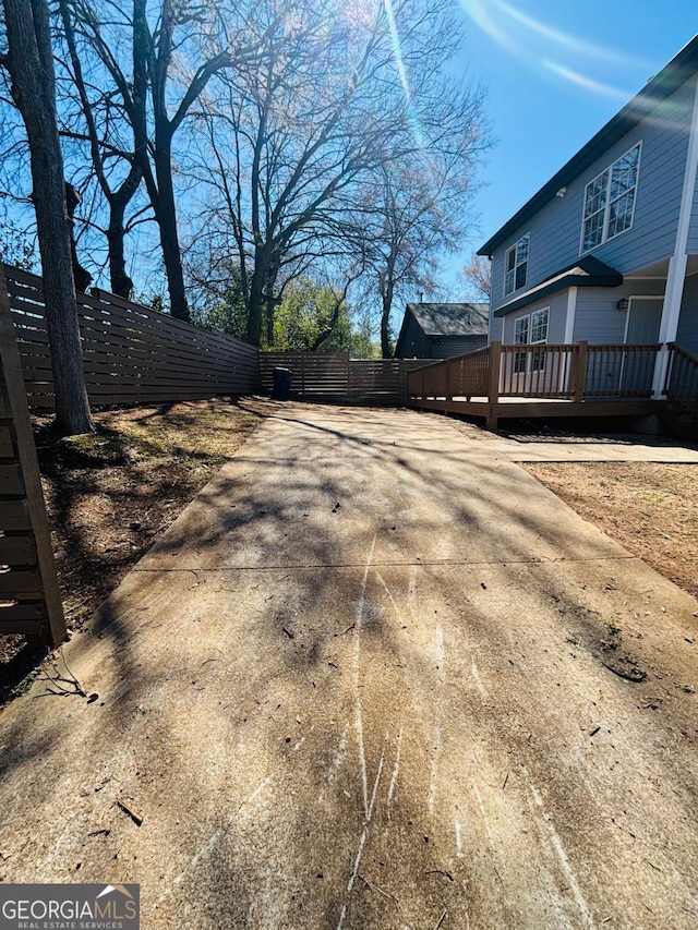 exterior space featuring fence and a deck