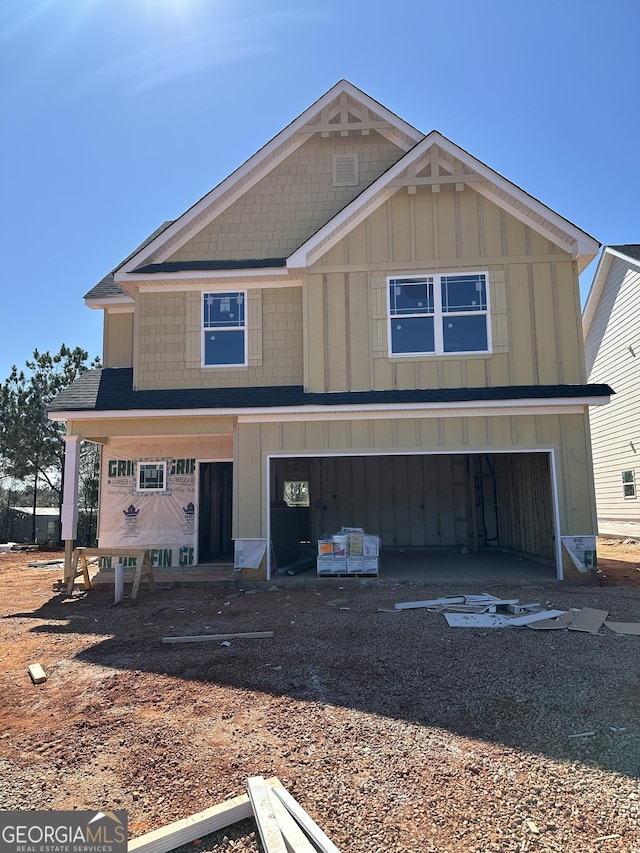 view of front of home featuring board and batten siding, driveway, and an attached garage