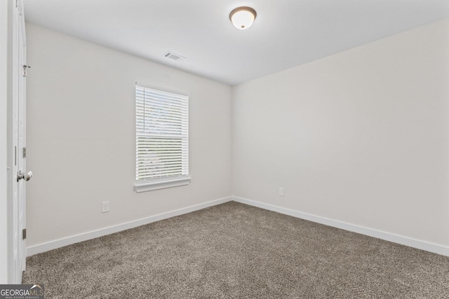 carpeted empty room with baseboards and visible vents
