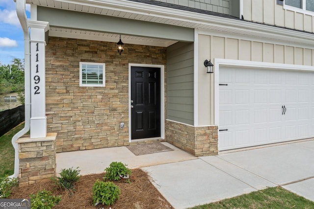 property entrance featuring board and batten siding, a porch, and stone siding