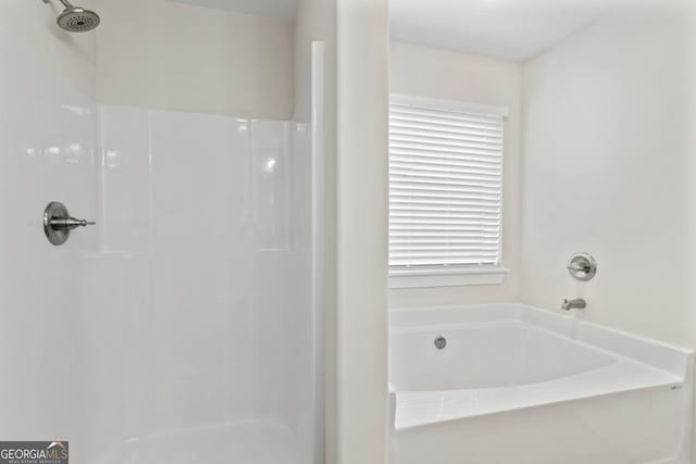 bathroom with walk in shower and a bath