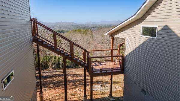 wooden deck with stairway and a mountain view