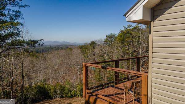 view of gate with a wooded view