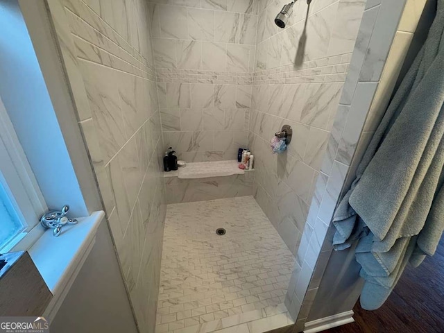 full bath featuring a tile shower