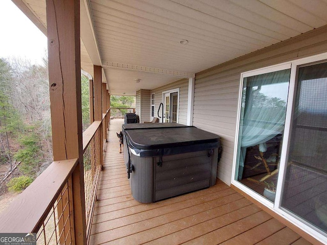 wooden terrace with a hot tub