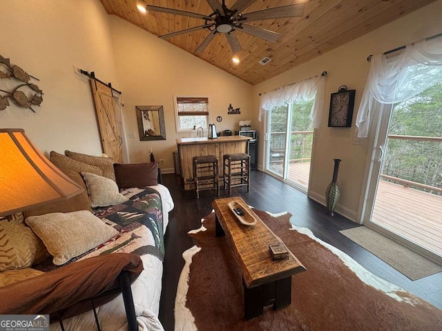 living area with a ceiling fan, wood ceiling, dark wood finished floors, and a barn door