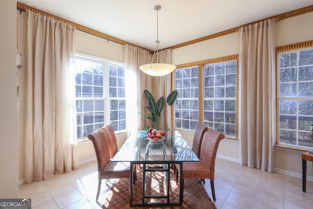 dining space with light tile patterned flooring and baseboards