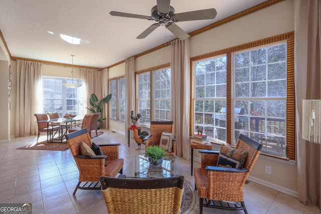 dining area with tile patterned flooring, a ceiling fan, and baseboards