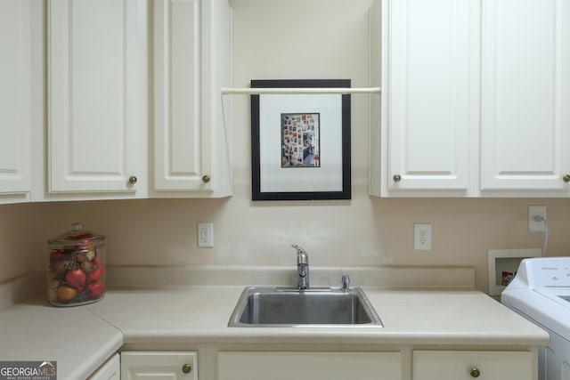 washroom featuring washer / dryer and cabinet space