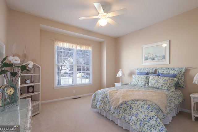 carpeted bedroom with baseboards, visible vents, and ceiling fan