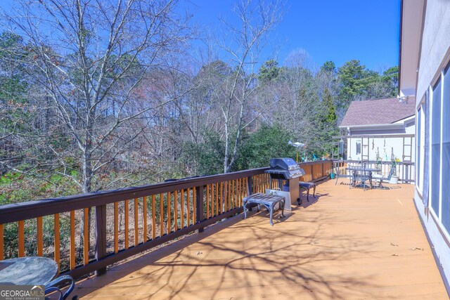 wooden deck featuring area for grilling