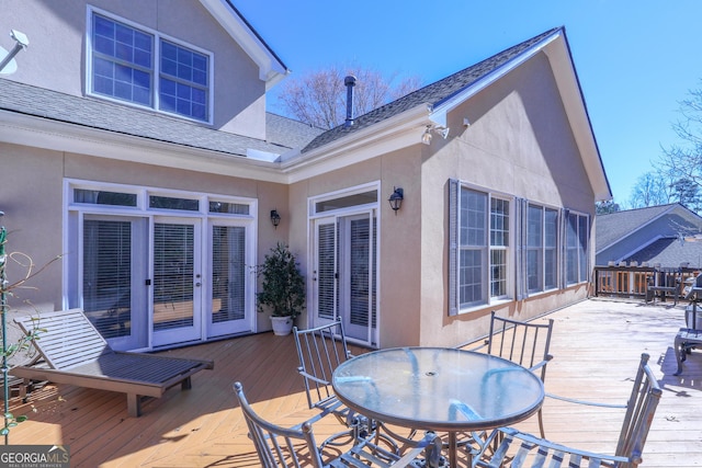 wooden deck featuring outdoor dining area and french doors