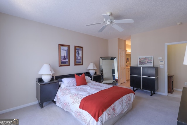 bedroom featuring light colored carpet, a textured ceiling, baseboards, and a ceiling fan
