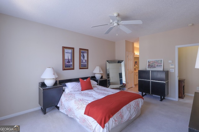 bedroom with baseboards, a textured ceiling, and light colored carpet