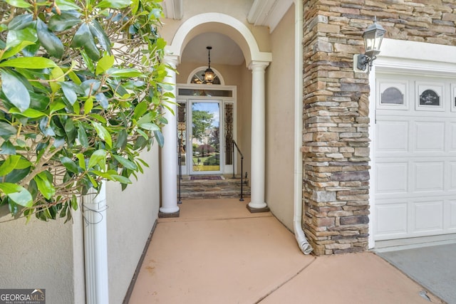 property entrance with stucco siding and stone siding