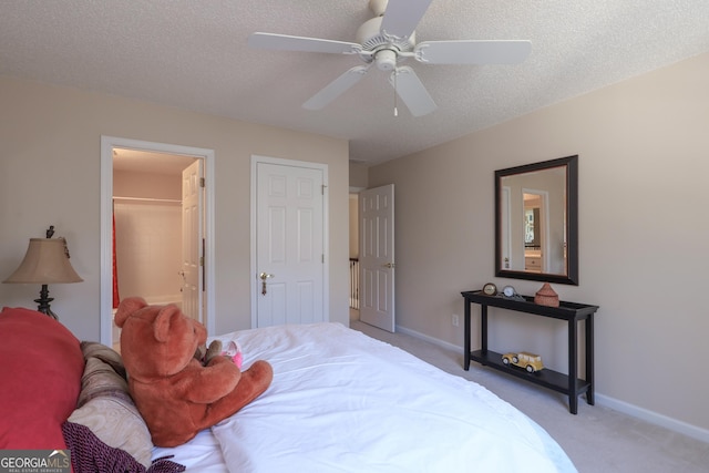 bedroom featuring a textured ceiling, carpet flooring, and baseboards