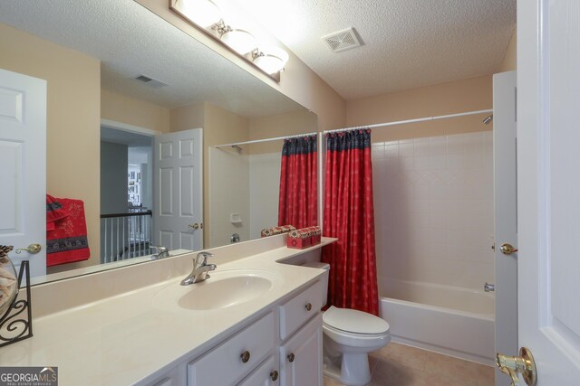 full bath with toilet, a textured ceiling, tile patterned floors, vanity, and shower / bathtub combination with curtain
