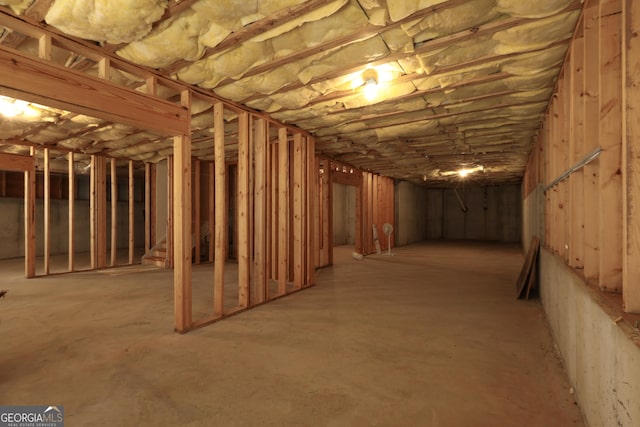 unfinished basement featuring stairway