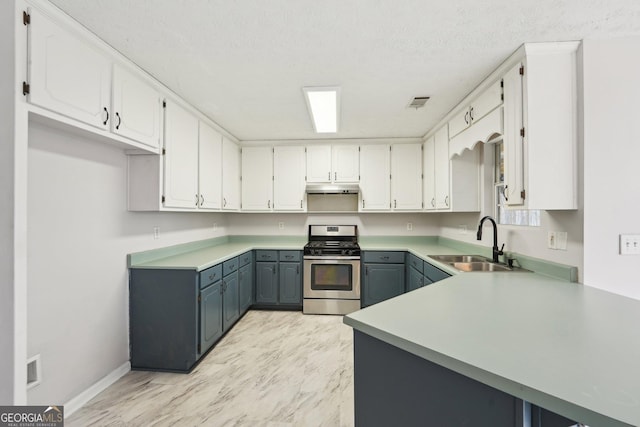 kitchen with gray cabinets, a sink, under cabinet range hood, white cabinetry, and gas range