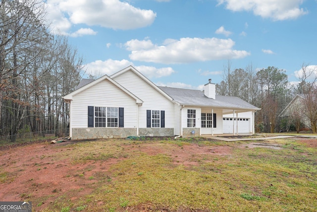 ranch-style house with a front lawn, fence, a garage, and a chimney