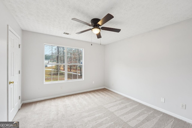 unfurnished bedroom with baseboards, visible vents, carpet floors, and a textured ceiling