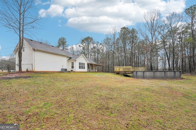 view of yard featuring central air condition unit and fence