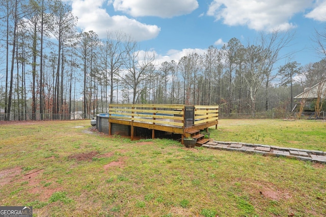 view of yard with a deck and fence