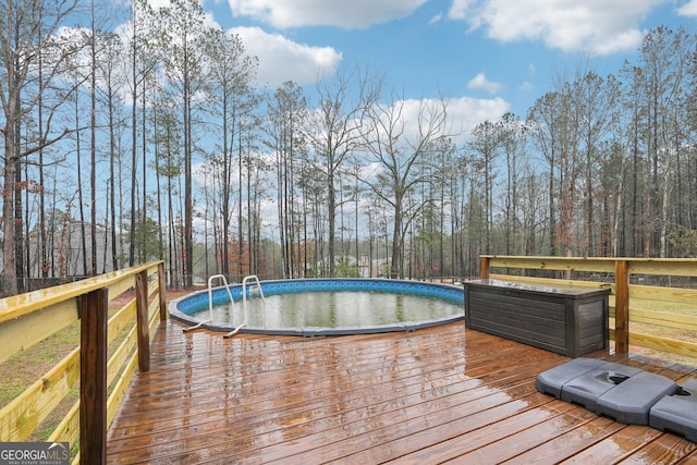 outdoor pool with a wooden deck