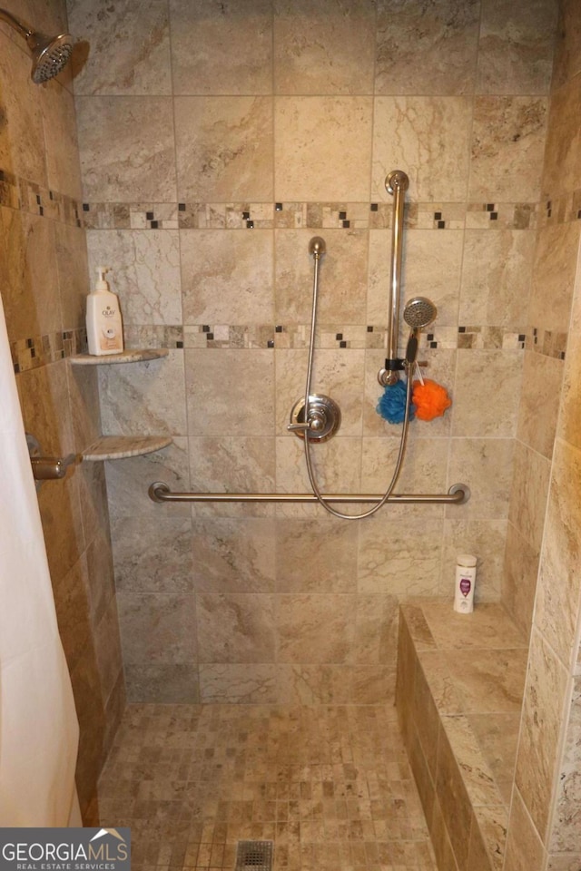 bathroom with tiled shower