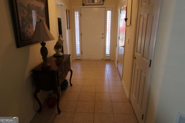 foyer with light tile patterned floors and visible vents